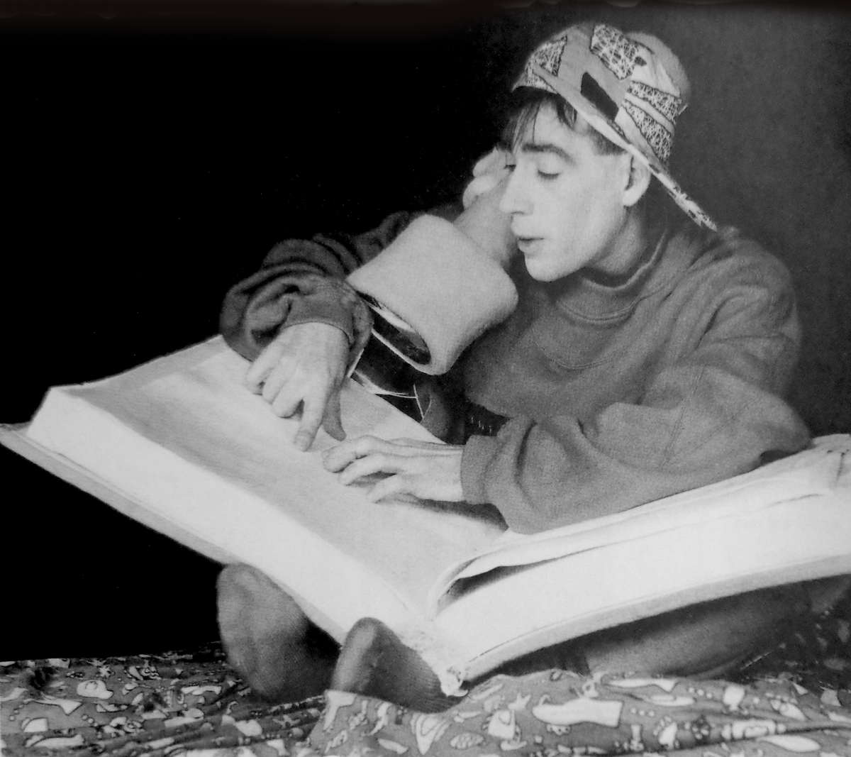 Handspan Theatre The Reading Boy boy in baseball cap reading a very big book