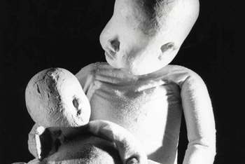 baby puppet cradling doll